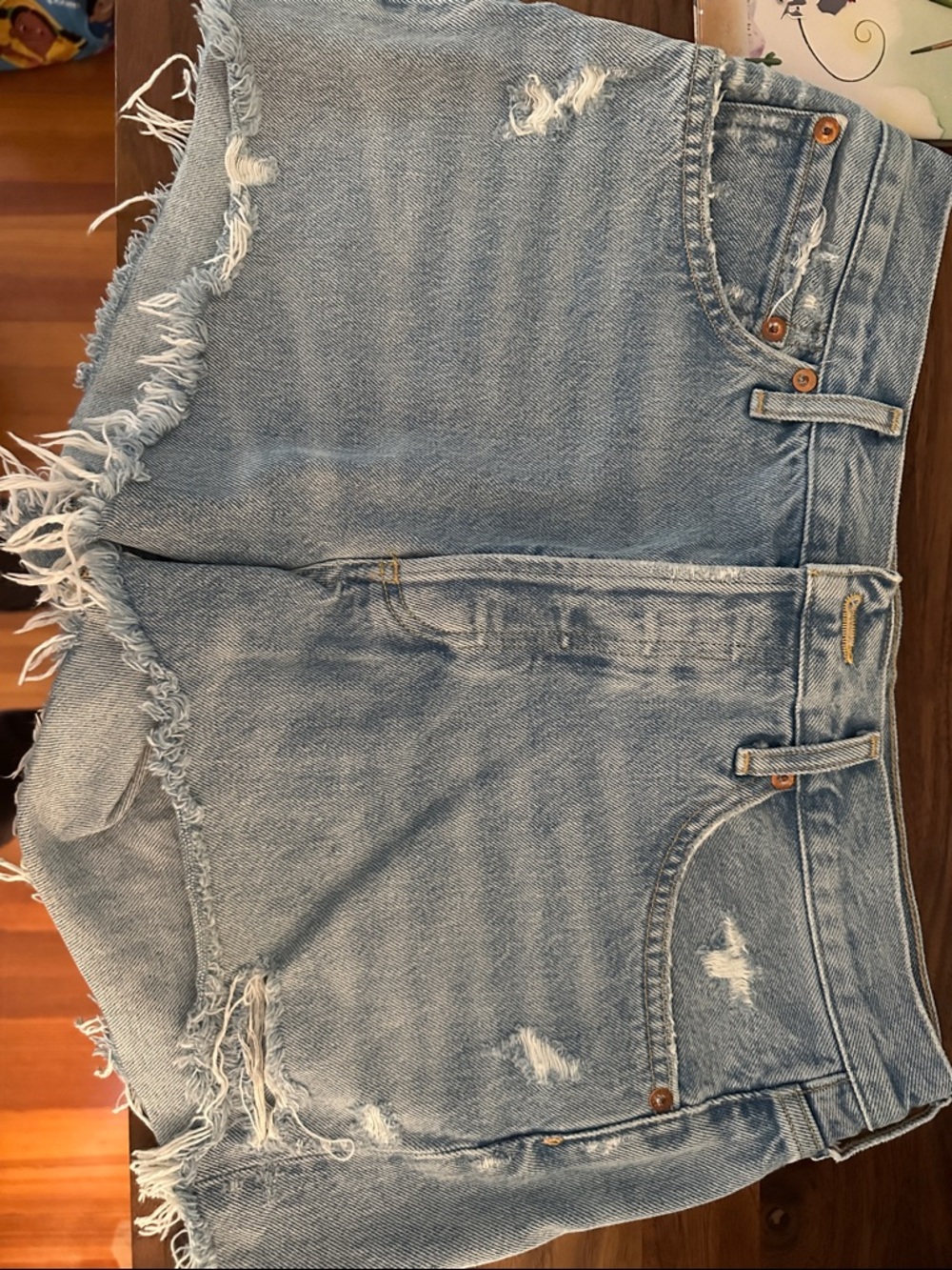Agolde Light Blue Distressed Denim Shorts with Frayed Hem